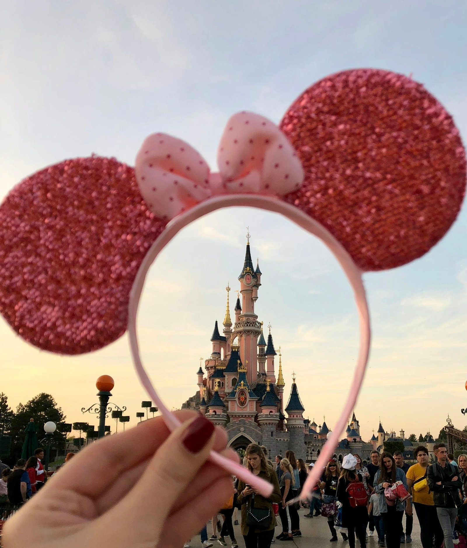 A sparkling headband frames the enchanting Disneyland Paris Castle, capturing the whimsical atmosphere.